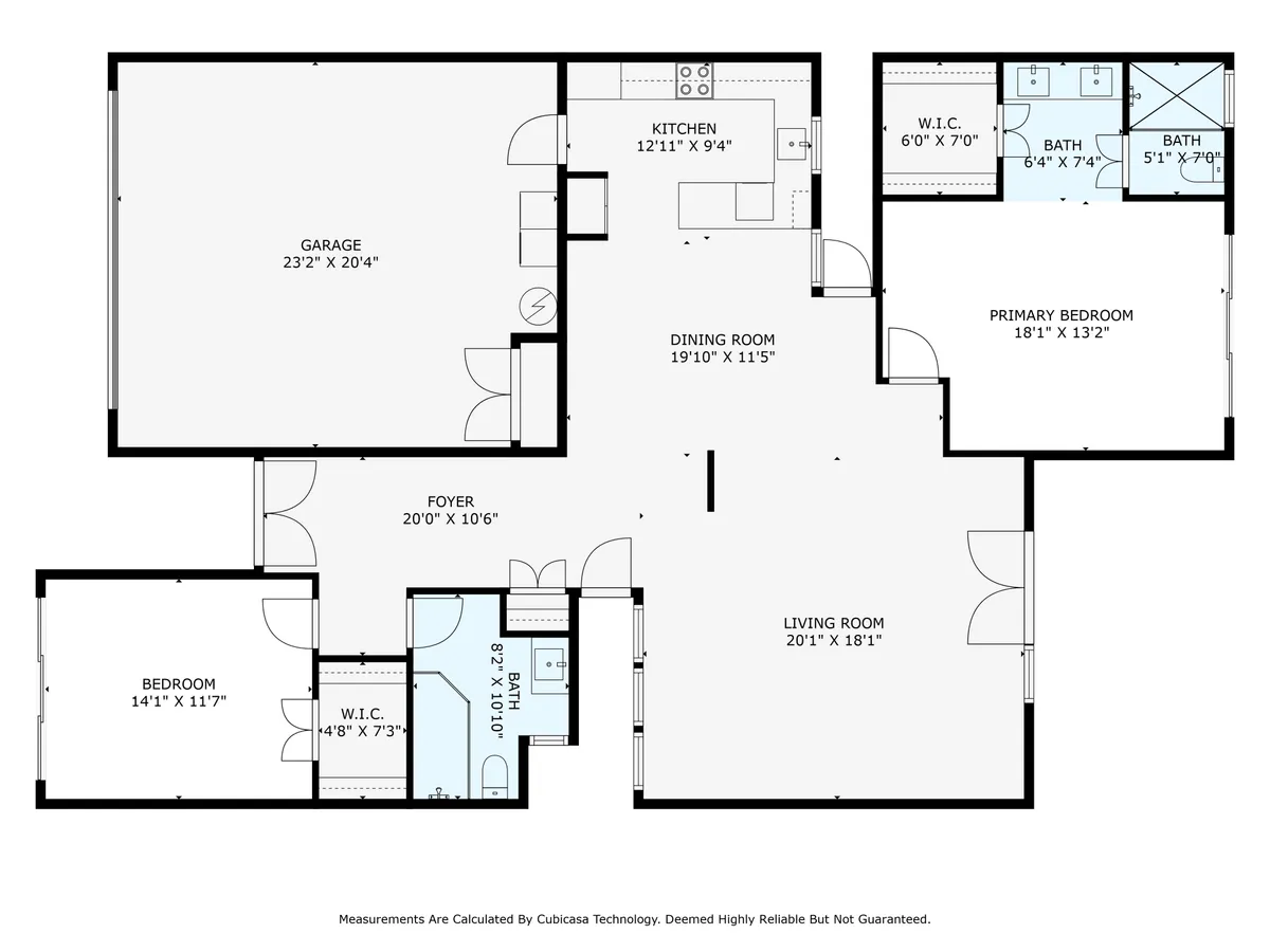 A spacious view from the interior showing the kitchen, living, dining room, primary bedroom, and the garage area. The shot provides a sense of the open-concept layout and how the garage connects to the main living space.